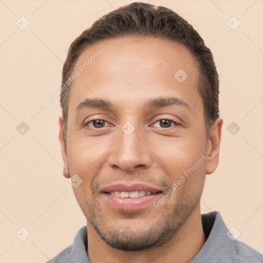 Joyful white young-adult male with short  black hair and brown eyes