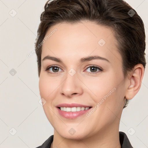 Joyful white young-adult female with short  brown hair and brown eyes