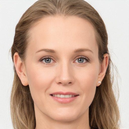 Joyful white young-adult female with long  brown hair and blue eyes