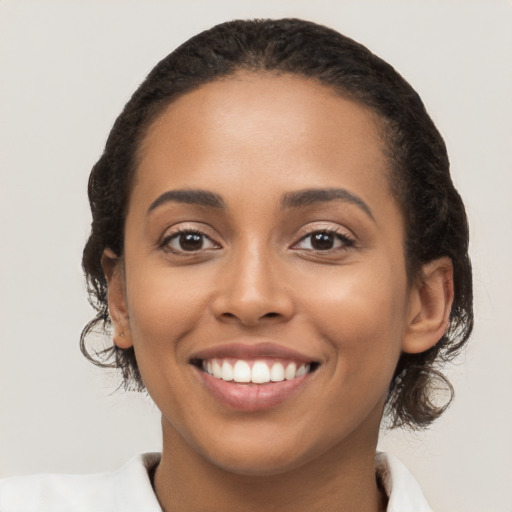 Joyful latino young-adult female with medium  brown hair and brown eyes