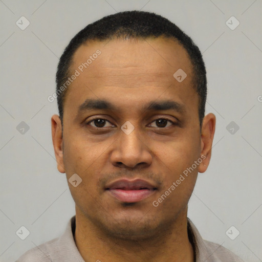 Joyful latino young-adult male with short  black hair and brown eyes