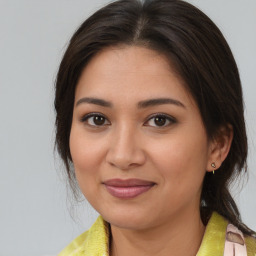 Joyful asian young-adult female with medium  brown hair and brown eyes