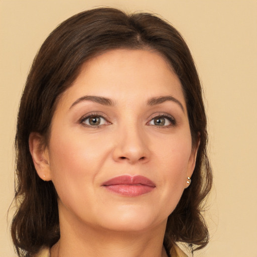 Joyful white young-adult female with medium  brown hair and brown eyes