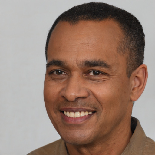 Joyful latino adult male with short  black hair and brown eyes