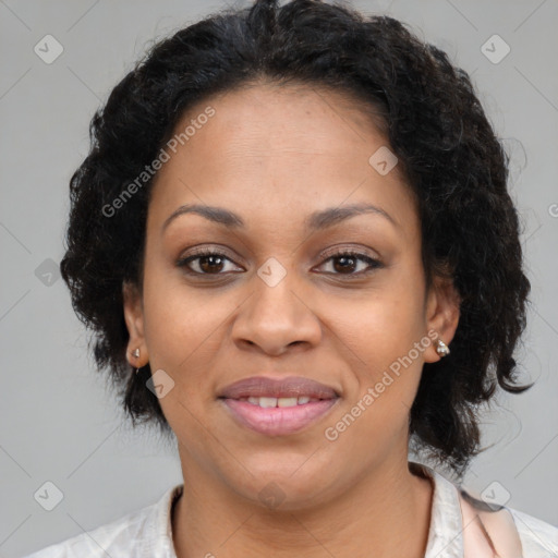 Joyful black adult female with medium  brown hair and brown eyes