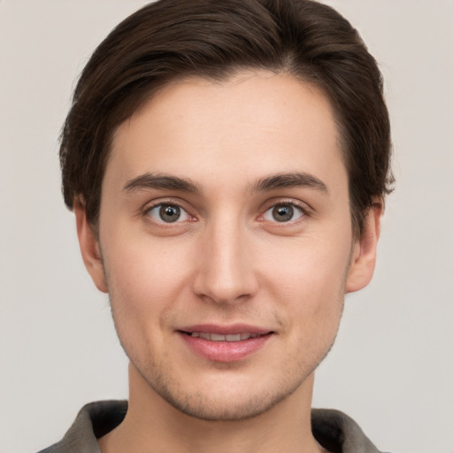 Joyful white young-adult male with short  brown hair and brown eyes