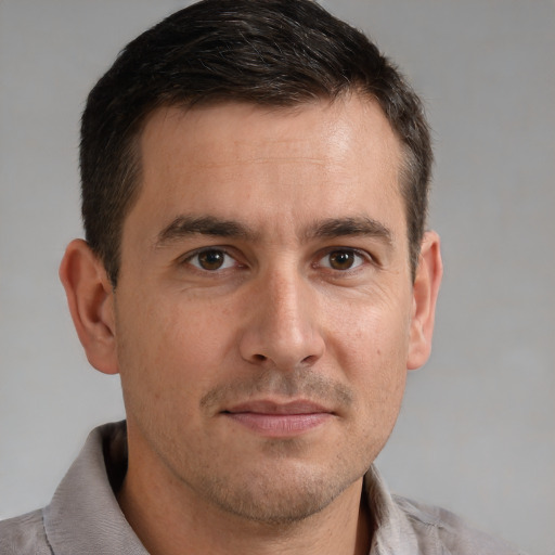 Joyful white adult male with short  brown hair and brown eyes