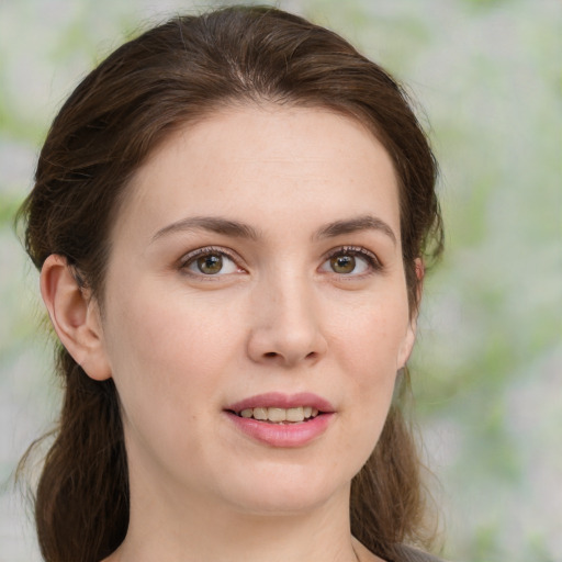 Joyful white young-adult female with medium  brown hair and green eyes