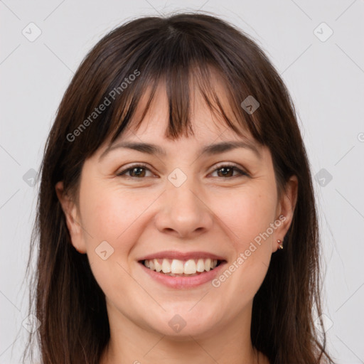 Joyful white adult female with long  brown hair and brown eyes