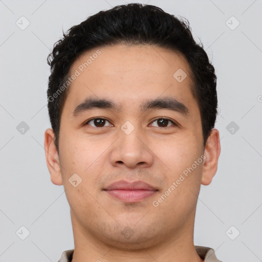 Joyful latino young-adult male with short  brown hair and brown eyes