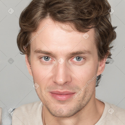 Joyful white young-adult male with short  brown hair and blue eyes