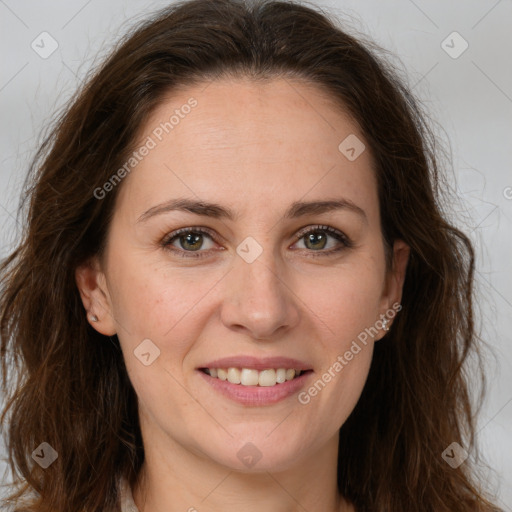 Joyful white adult female with long  brown hair and brown eyes