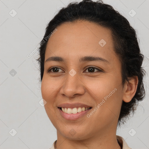 Joyful latino young-adult female with short  brown hair and brown eyes