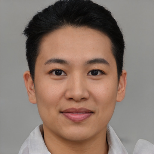 Joyful asian young-adult male with short  brown hair and brown eyes