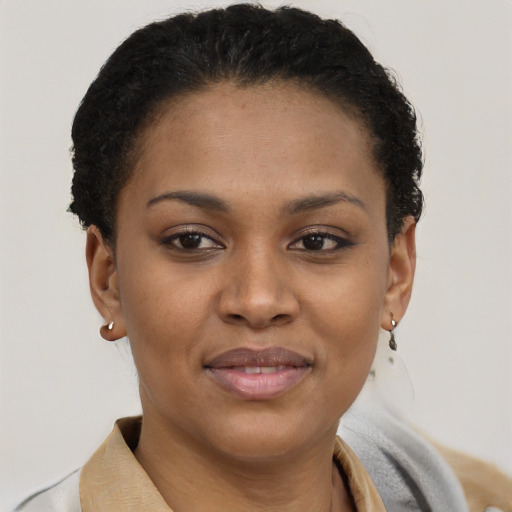 Joyful black young-adult female with short  brown hair and brown eyes