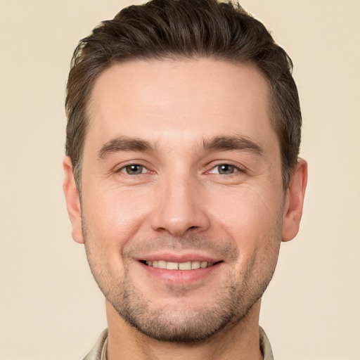 Joyful white young-adult male with short  brown hair and brown eyes