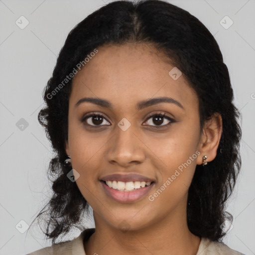 Joyful black young-adult female with long  black hair and brown eyes