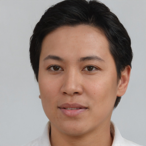 Joyful asian young-adult female with short  brown hair and brown eyes