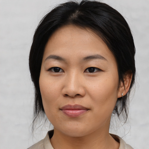 Joyful asian young-adult female with medium  black hair and brown eyes