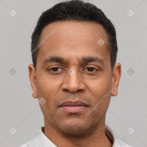 Joyful latino adult male with short  black hair and brown eyes