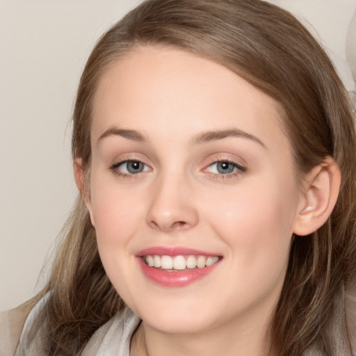 Joyful white young-adult female with long  brown hair and blue eyes