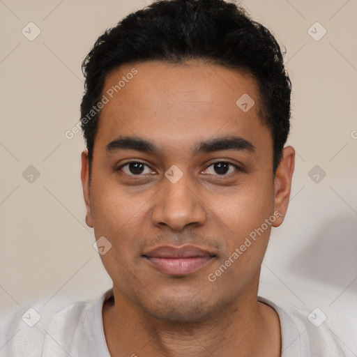 Joyful latino young-adult male with short  black hair and brown eyes