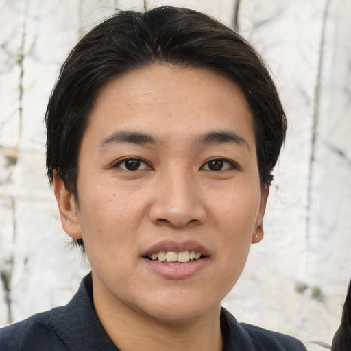 Joyful asian young-adult male with short  black hair and brown eyes