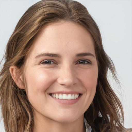 Joyful white young-adult female with long  brown hair and grey eyes