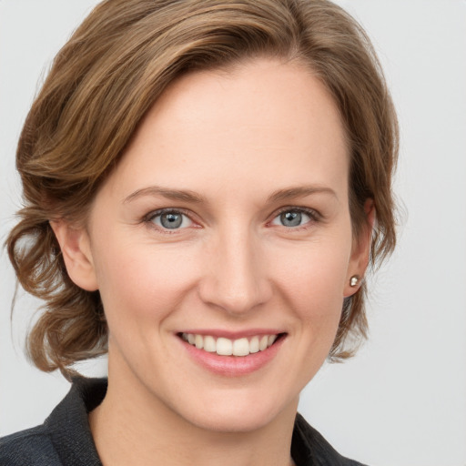 Joyful white young-adult female with medium  brown hair and blue eyes