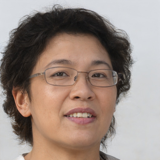 Joyful asian adult female with medium  brown hair and brown eyes