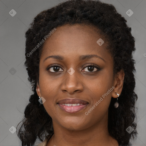 Joyful black young-adult female with long  brown hair and brown eyes