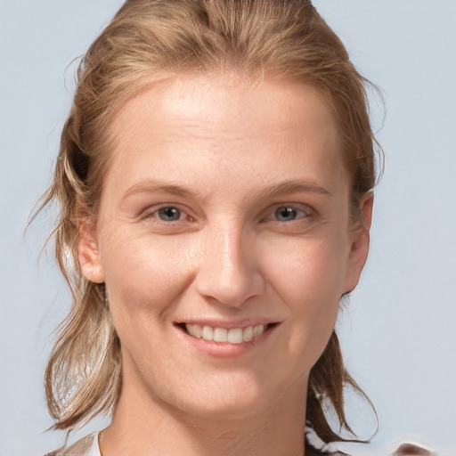 Joyful white young-adult female with medium  brown hair and blue eyes