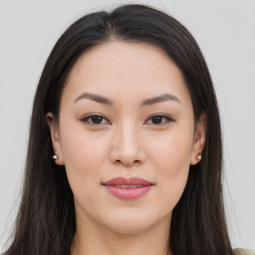 Joyful asian young-adult female with long  brown hair and brown eyes