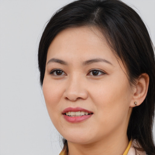 Joyful asian young-adult female with medium  brown hair and brown eyes