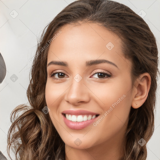 Joyful white young-adult female with long  brown hair and brown eyes