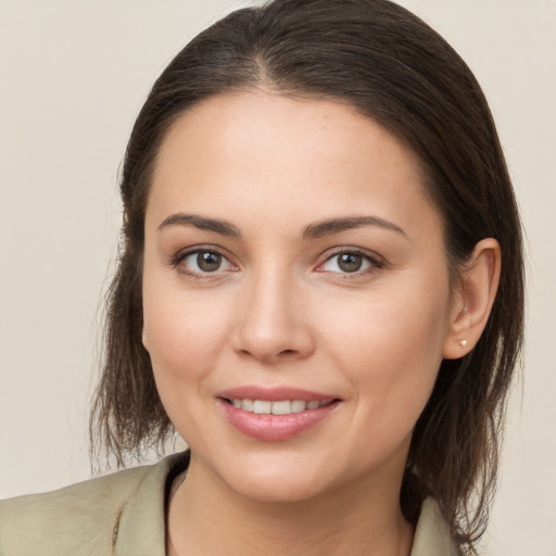 Joyful white young-adult female with medium  brown hair and brown eyes