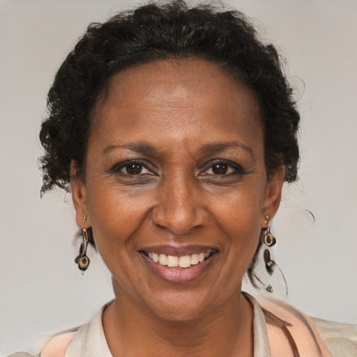 Joyful black adult female with medium  brown hair and brown eyes
