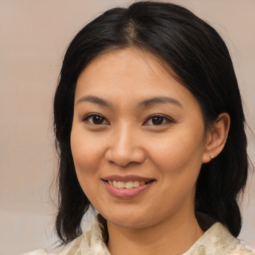 Joyful asian young-adult female with medium  brown hair and brown eyes