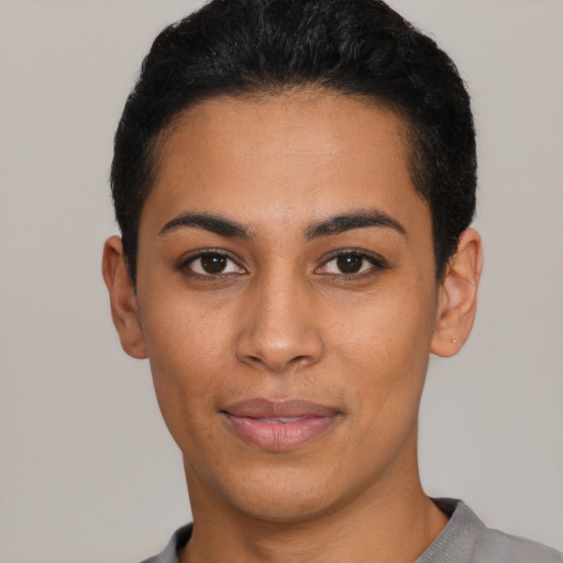 Joyful latino young-adult female with short  black hair and brown eyes