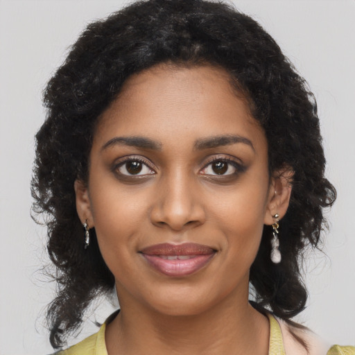 Joyful black young-adult female with medium  brown hair and brown eyes