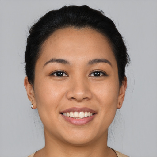 Joyful latino young-adult female with medium  black hair and brown eyes