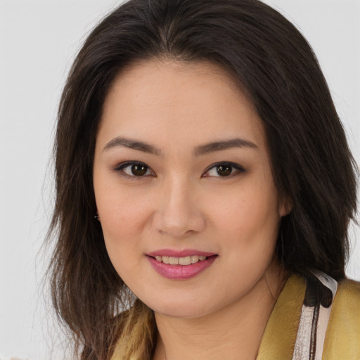 Joyful asian young-adult female with long  brown hair and brown eyes