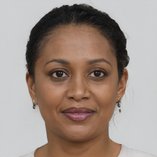 Joyful black adult female with short  brown hair and brown eyes
