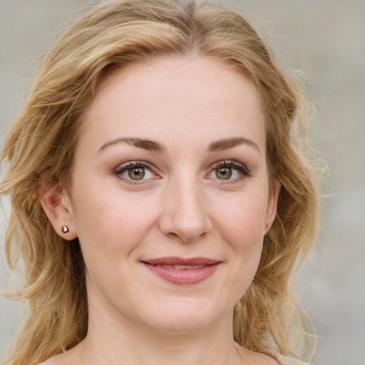 Joyful white young-adult female with medium  brown hair and green eyes