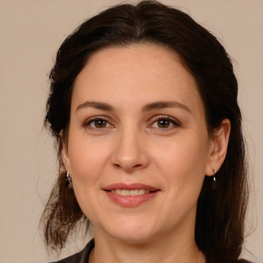 Joyful white adult female with medium  brown hair and brown eyes