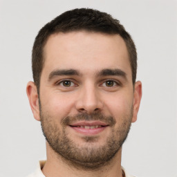 Joyful white young-adult male with short  brown hair and brown eyes