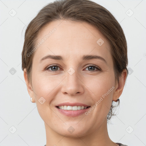 Joyful white young-adult female with short  brown hair and grey eyes