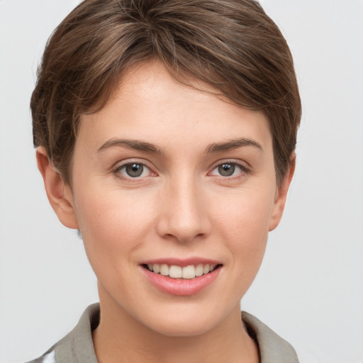 Joyful white young-adult female with short  brown hair and grey eyes