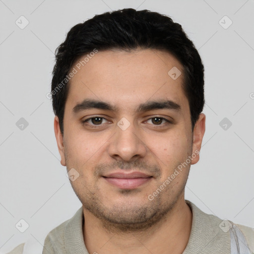 Joyful latino young-adult male with short  black hair and brown eyes