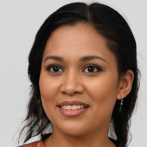 Joyful latino young-adult female with medium  brown hair and brown eyes